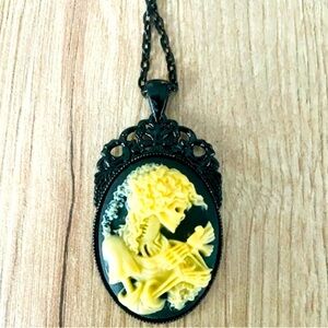Black and yellow Skeleton lady holding a bird cameo Victorian Style Necklace